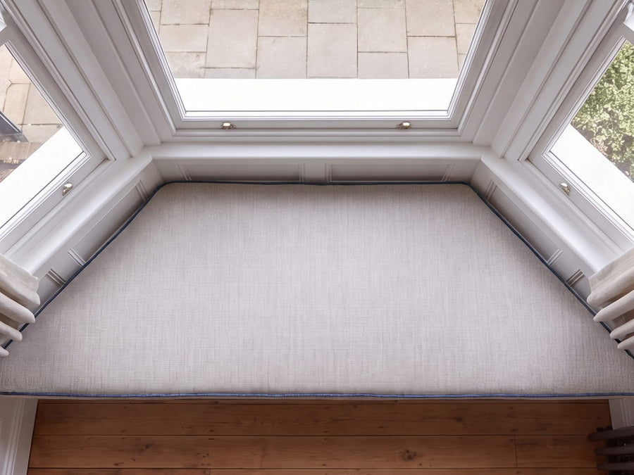 A cushion cut to follow the angled ends of a bay window seat