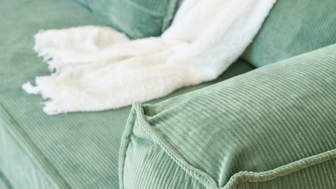 Green corduroy sofa, close-up of the wale ribs and nap