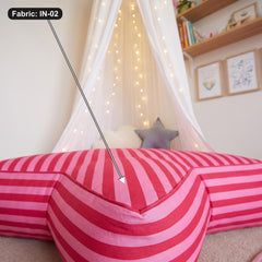 Giant star floor cushion styled in a playroom