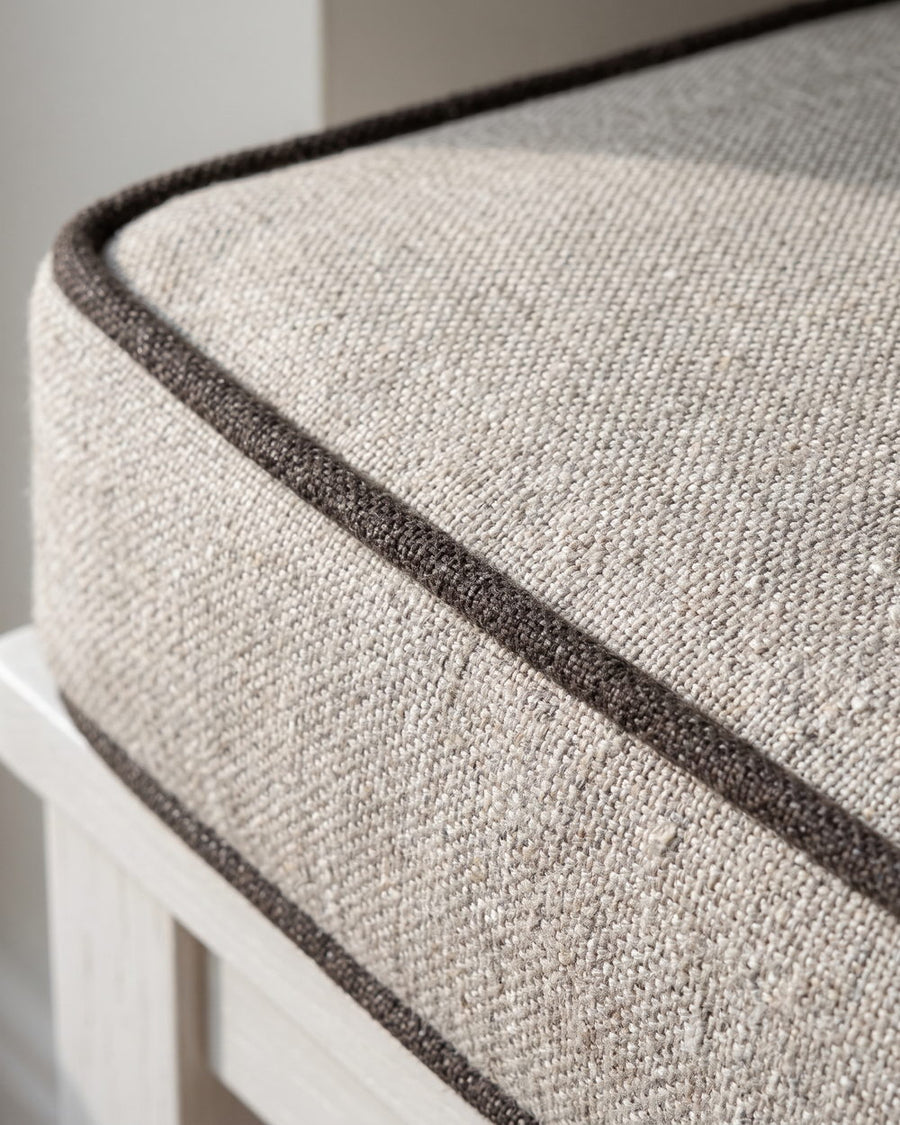 Close-up of contrast piping along the edge of a cushion