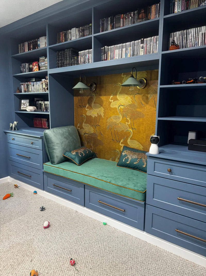 Customer photo: green cushion in a built-in reading nook between blue bookshelves