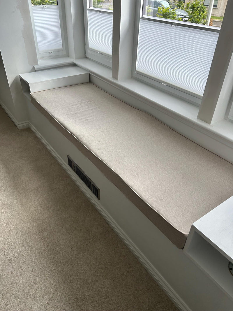 Customer photo: long oatmeal cushion on a white window seat beneath three windows