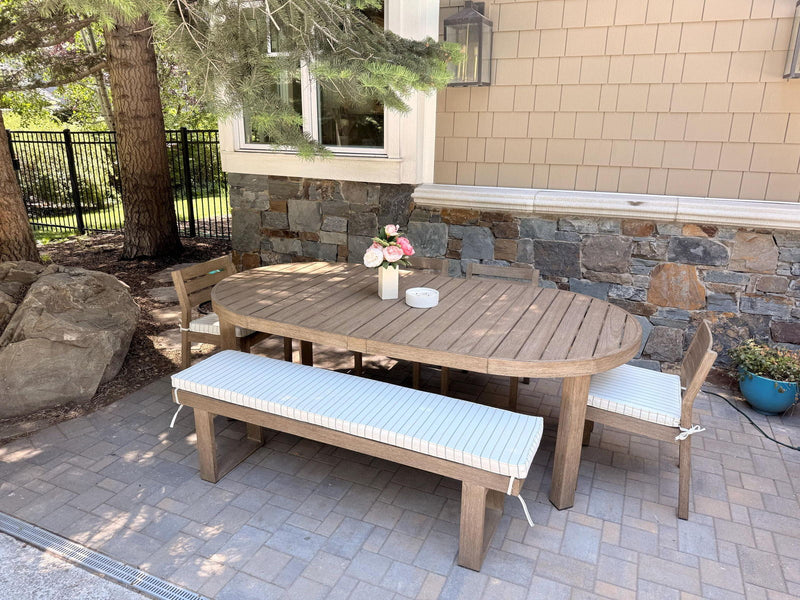 Customer photo: outdoor bench and chair cushion covers around a teak dining table