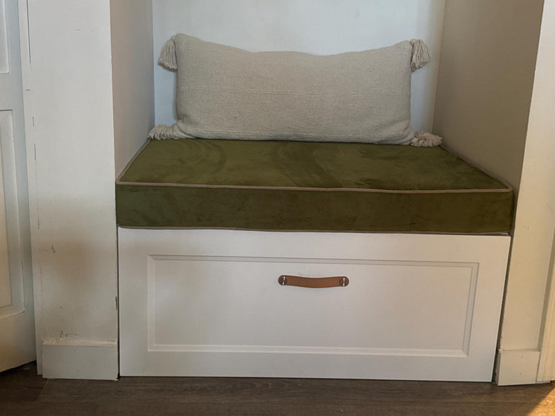 Customer photo: olive velvet cushion with piping on a white storage bench in an alcove