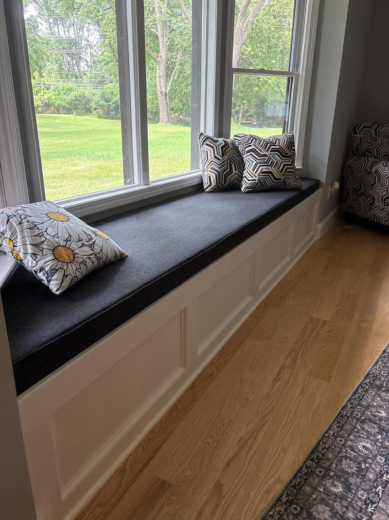 Customer photo: charcoal cushion along a white bay window seat with patterned pillows