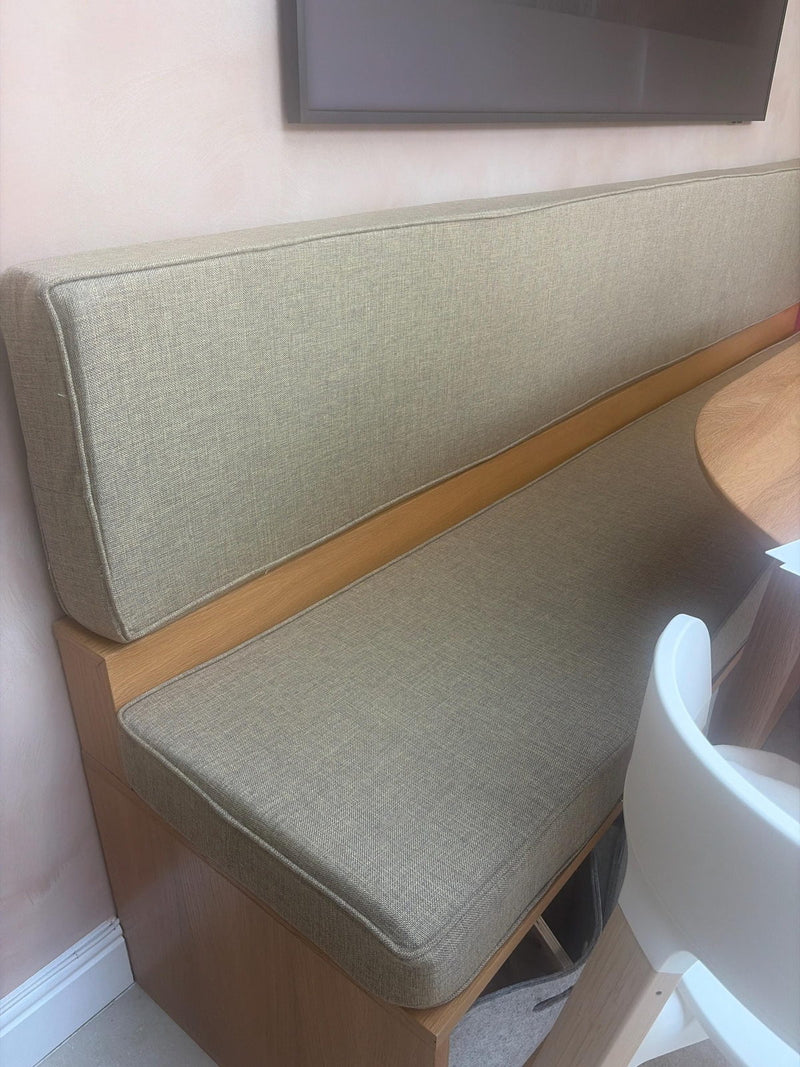 Customer photo: sage seat and backrest cushions on a wooden banquette